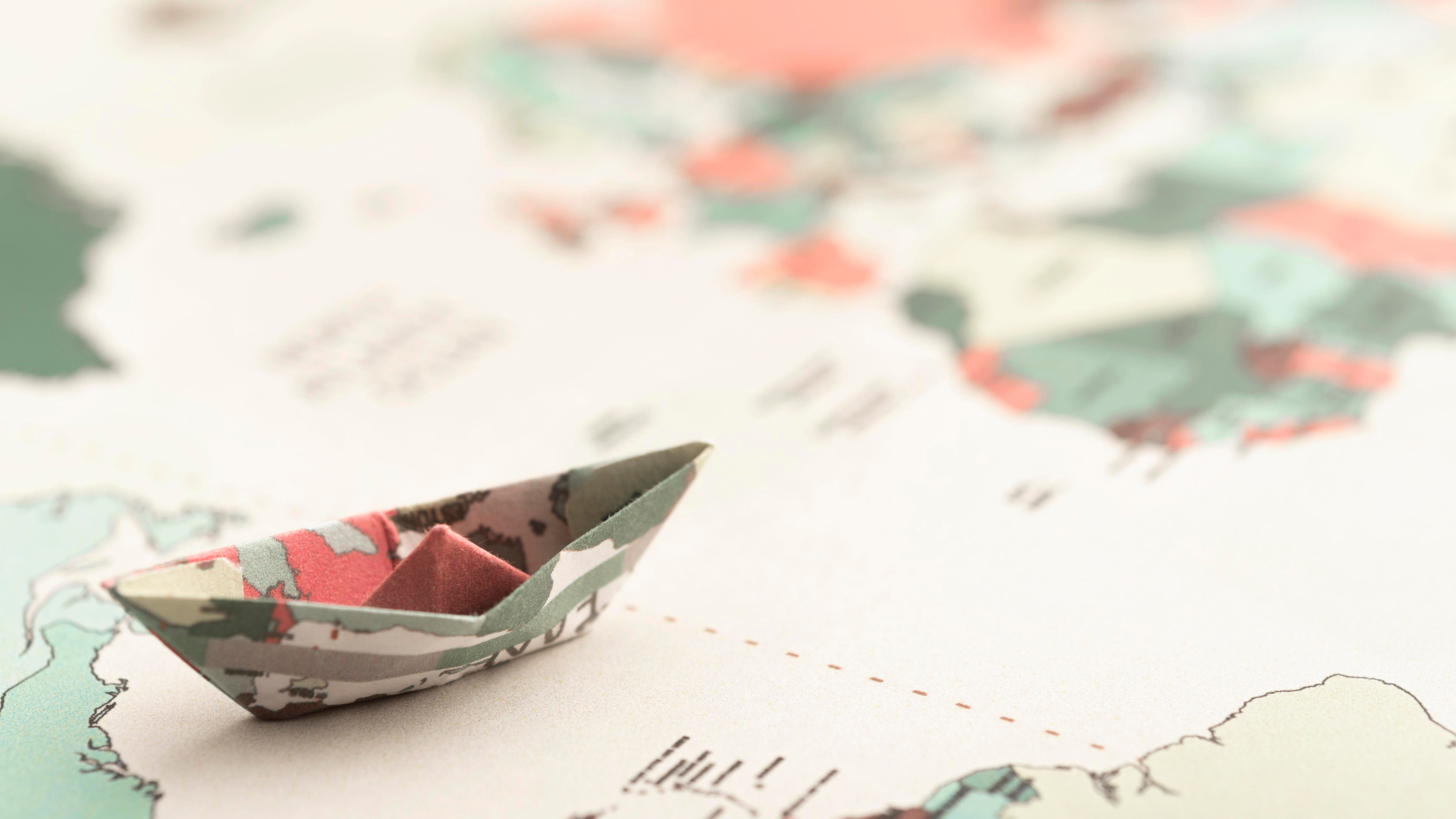 high-angle-small-origami-boat-world-map.jpg